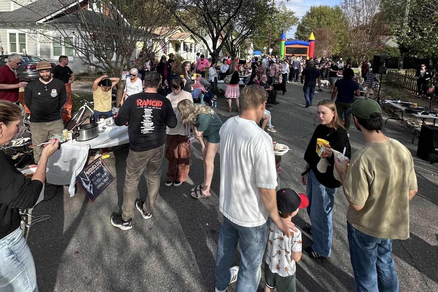 Neighbors gathered around chili tables on Newton Avenue at a past block party